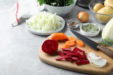 Fresh ingredients for borscht on light grey table