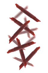 Delicious fruit leather rolls falling on white background