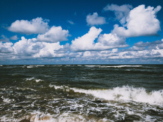 vivid seascape, beautiful sea with waves and blue sky with white clouds, natural background