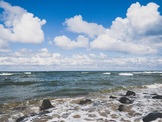 vivid seascape, beautiful sea with waves and blue sky with white clouds, natural background
