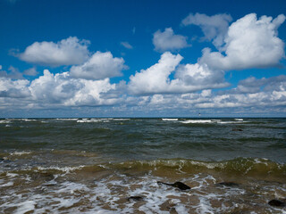 vivid seascape, beautiful sea with waves and blue sky with white clouds, natural background