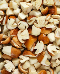 Food  background. Top view chopped porcini. Sliced raw edible mushroom. Boletus edulis. Heap of fresh mushrooms.  Closeup