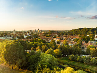 Beautiful Vilnius city panorama in autumn with orange and yellow foliage. Aerial evening view.