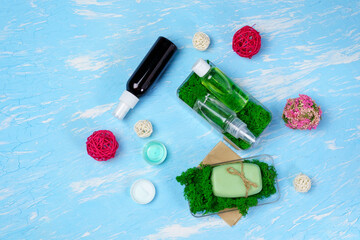 Soap lotion with green moss, cosmetics for body care on a blue background, moss.