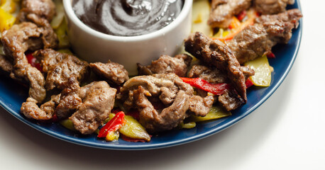 Beef strips with mixed peppers and mangetout served with black bean sauce