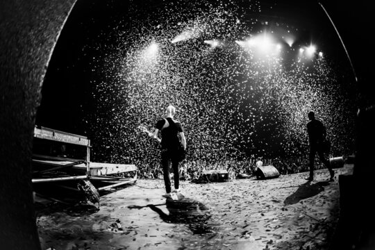 Band on stage. Music show. Bright lights and shiny confetti at a pop concert.