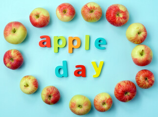 Apple is a national holiday on October 21. Red apples on a blue background. Flat lay.