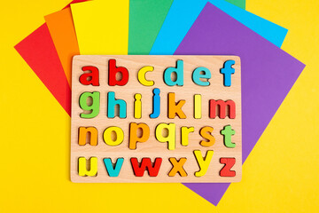 Colorful letters of the English alphabet colorful background. The concept of education in kindergarten and school. Flat Lay