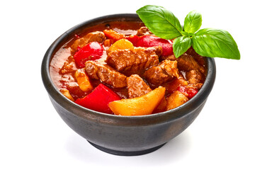 Hungarian goulash, meat stew in a rustic pot, isolated on white background.