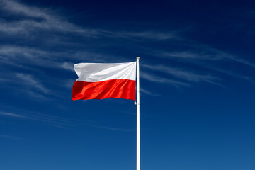 Fototapeta na wymiar Beautiful Polish flag with blue sky on background
