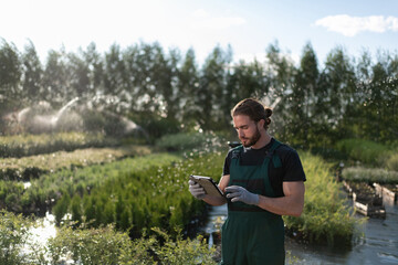 Male farmer using tablet on farm