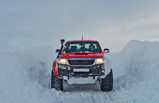 customised 4x4 pick up truck driving through deep snow