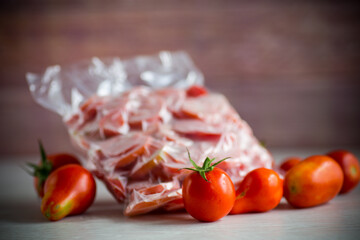 frozen tomatoes in a vacuum bag on table