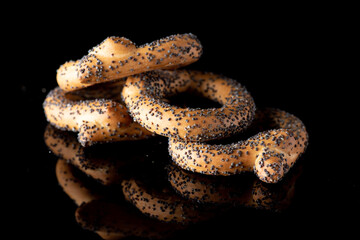 Confectionery flour bagels on a dark background.