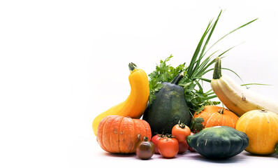 Fototapeta na wymiar Organic vegetables pumpkins, squash, zucchini, tomatoes, parsley on white. Harvest concept with copy space.