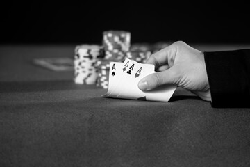 Close-up of hands with four aces in black and white