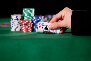 Close-up of hands with pair of kings in poker