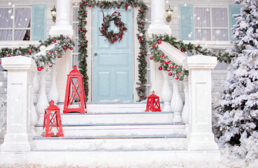Christmas porch.Snowy courtyard with Christmas porch, veranda, wreath, Christmas tree,...