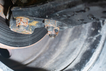 Metal suspension lever car. Suspension bracket stabilizer suspension. Wheel with brake disc. Defocused bottom view.