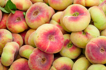 Fresh ripe flat peaches harvested from the orchard