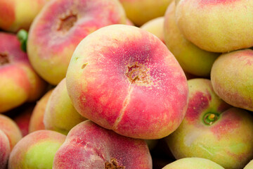 Fresh ripe flat peaches harvested from the orchard