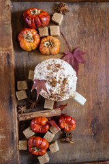 Autumn still life with a cup of coffee and autumn leaves on a wooden background