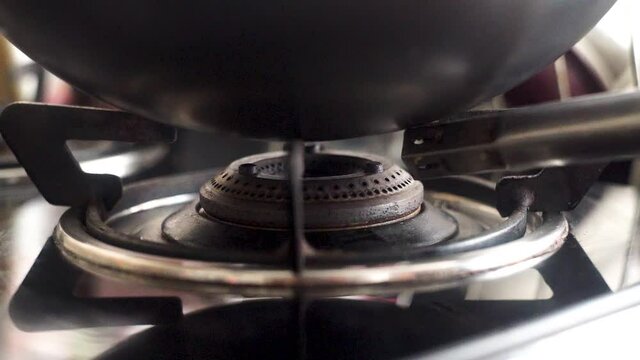 Slow motion 120 FPS shot close up shot of natural petroleum cooking gas burner with a blue red flame used in India for cooking food and heating items given by companies like Indian Oil corporation