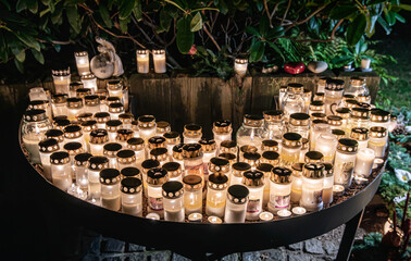Grave candles on a cemetery on all saints eve.