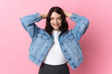 Teenager Ukrainian girl isolated on pink background laughing