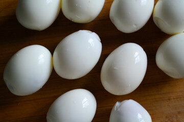 Closeup of whole boiled eggs on a wooden tab