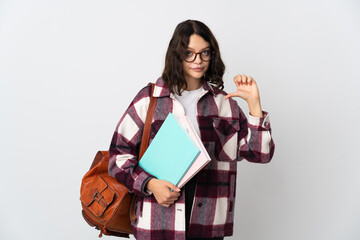 Teenager Ukrainian student isolated on white background showing thumb down with negative expression