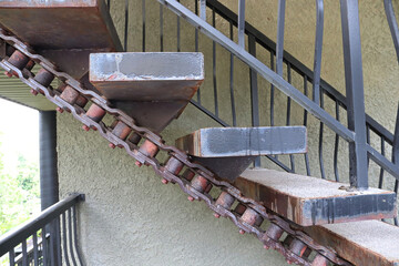 Closeup of large stairs made with large machinery chains