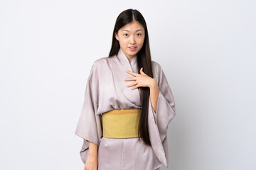 Young Chinese girl wearing kimono over isolated background pointing to oneself