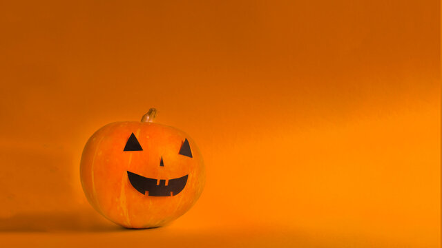 pumpkin halloween on orange background with copy space