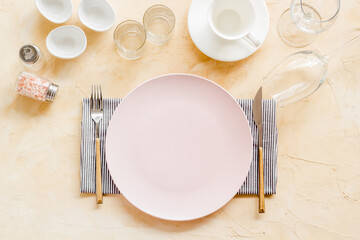 Dinner plate setting with cutlery and napkin. Top view