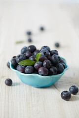 blueberries on a white wooden surface
