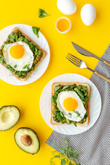 Toasts with avocado and fried eggs. Healthy breakfast