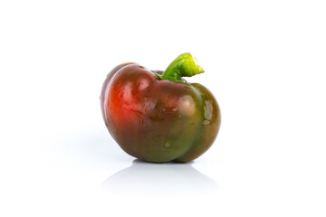Red raw bell pepper on the white gloss background