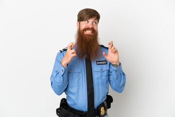 Redhead police man isolated on white background with fingers crossing