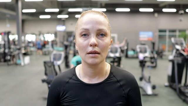 a middle-aged woman works out in the gym on a treadmill to lose excess weight. healthy lifestyle
