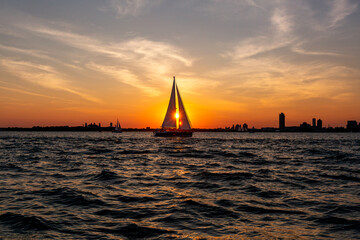 Sailboat at sunset in New York Harbor