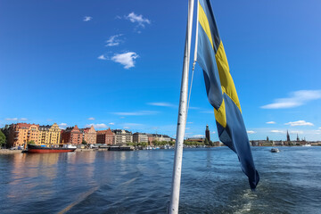 Skyline of Stockholm, Sweden with the Swedish flag in the foreground