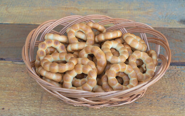 Some delicious bagels in a basket on a wooden background
