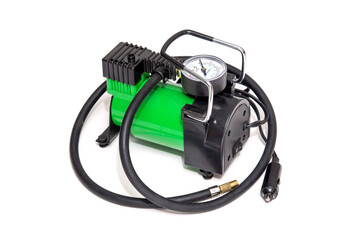 Car pump with manometer, green air compressor on white background. Inflating the wheels with air in the car.