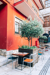 Fototapeta na wymiar Antalya, Turkey - July, 2021: Cozy outdoor cafe in old town Kaleici district in Antalya, Turkey.