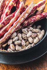 Cranberry beans. Borlotti beans in bowl. Beans pods