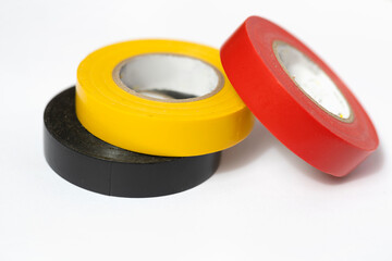 Insulation tapes: yellow, red and black  for elecrics against white background