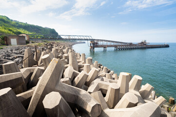 Obraz premium Concrete breakwater stones/structures known as dolosse, designed to dissipate the energy from the sea safely
