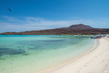 Beautiful white sand beach with crystal clear water in the tranquility of the sea of Cortes in Baja...