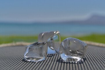 Ice cubes on a blurry background of the sea.